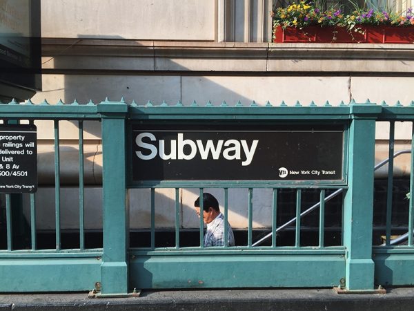 man going to the NYC subway station