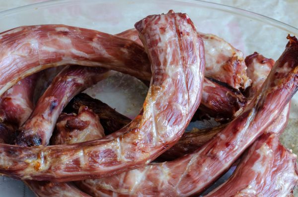 Sun-dried turkey necks in a glass dish